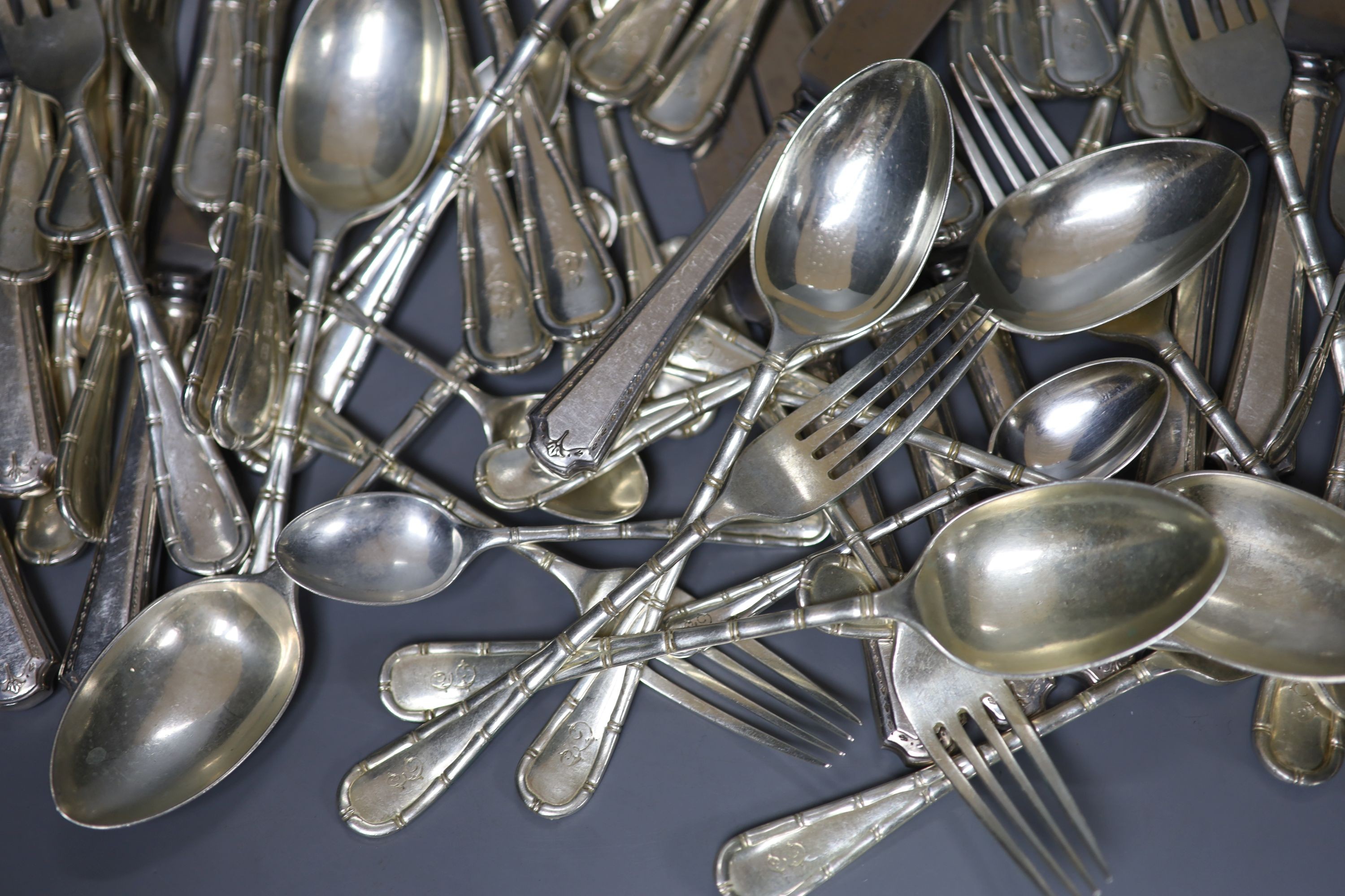 A part canteen of Edwardian silver cutlery by Atkin Brothers, Sheffield, 1903, with engraved initial, comprising forty nine items, 108oz, together with twelve later associated silver plated handled steel table knives.